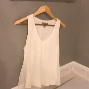 Off-white sleeveless blouse.